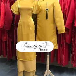 ÁO DÀI BƯNG QUẢ CẶP VÀNG ĐỒNG TAY CÁNH TIÊN