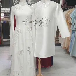 ÁO DÀI CẶP TRẮNG CÁCH ĐIỆU XẺ TÀ KẾT PHA LÊ