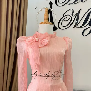 ÁO DÀI BƯNG QUẢ NỮ MÀU CAM SỮA NƠ CỔ 