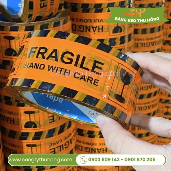 Băng keo cảnh báo in hàng dễ vỡ nền cam Băng keo cảnh báo in hàng dễ vỡ nền cam