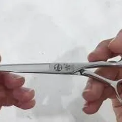 Sharpening professional barber scissors after grinding like new scissors