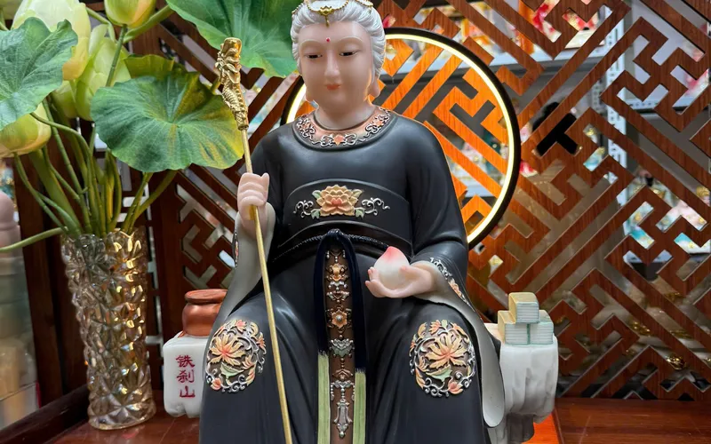 Bà Cố Hỷ tay cầm quả Đào