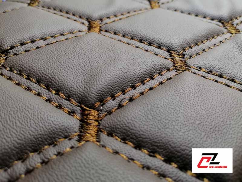 Cận cảnh bề mặt da PVC hình thoi nhẵn nâu chỉ nây 2 đường chỉ Cận cảnh bề mặt da PVC hình thoi nhẵn nâu chỉ nây 2 đường chỉ