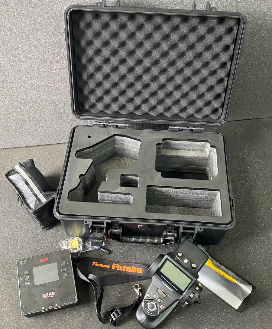 Khoang xốp định hình trong vali nhựa và bộ điều khiển xe mô hình RC, bộ sạc, túi pin đặt bên ngoài