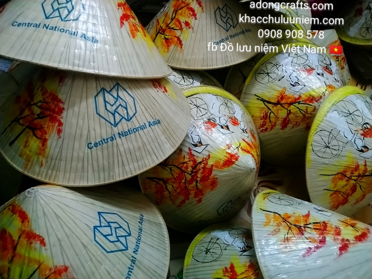 Nón lá in logo công ty và vẽ hình cô gái Việt Nam đạp xe đạp đội nón lá