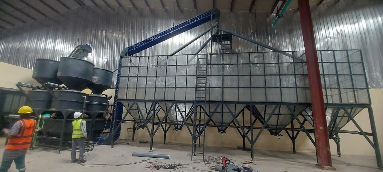 Technicians installing and commissioning cashew processing machinery Technicians installing and commissioning cashew processing machinery