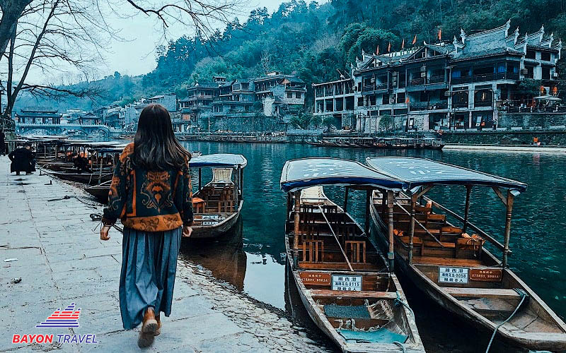 Khách du lịch sẽ được đi tham quan cổ trấn bằng những chiếc xuồng trên con sông thơ mộng trong chương trình tour Phượng Hoàng cổ trấn từ TPHCM Khách du lịch sẽ được đi tham quan cổ trấn bằng những chiếc xuồng trên con sông thơ mộng trong chương trình tour Phượng Hoàng cổ trấn từ TPHCM