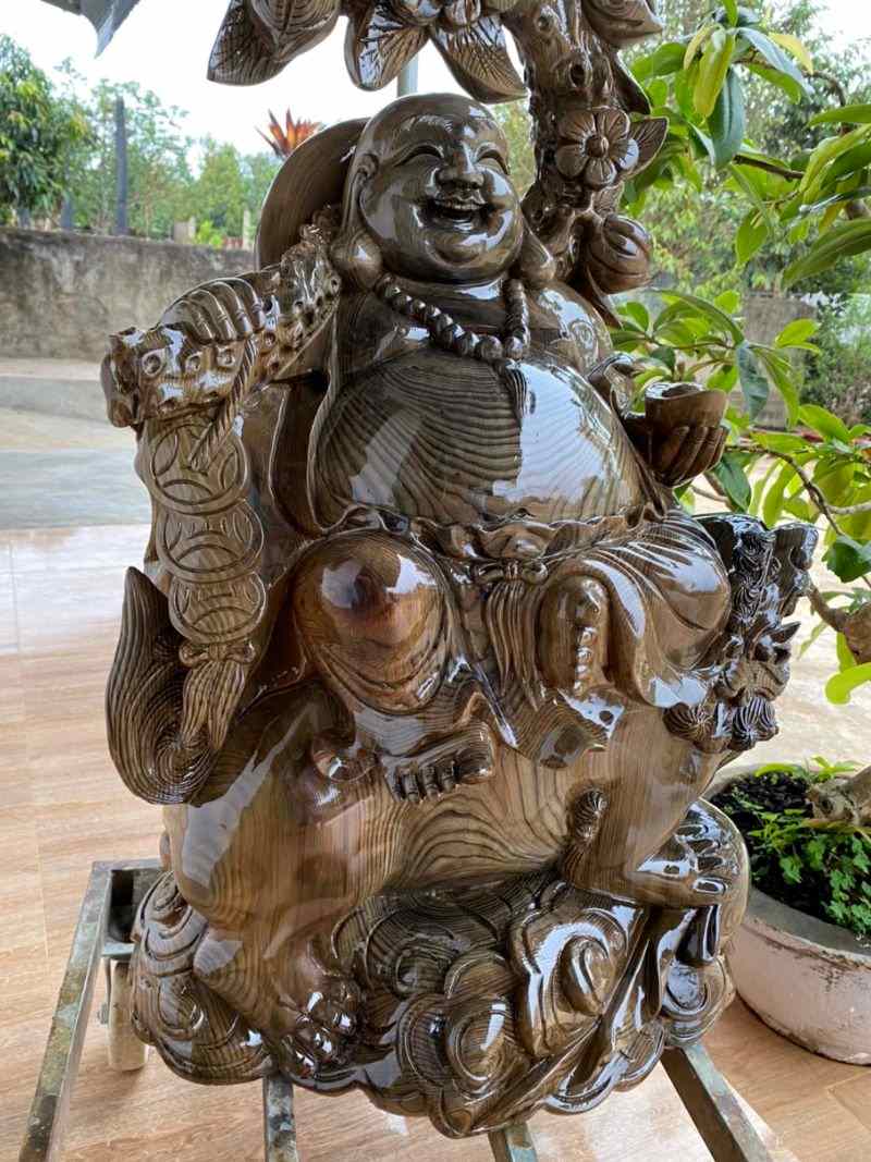 Phật di lặc cưỡi lân gỗ thủy tùng Phật di lặc cưỡi lân gỗ thủy tùng